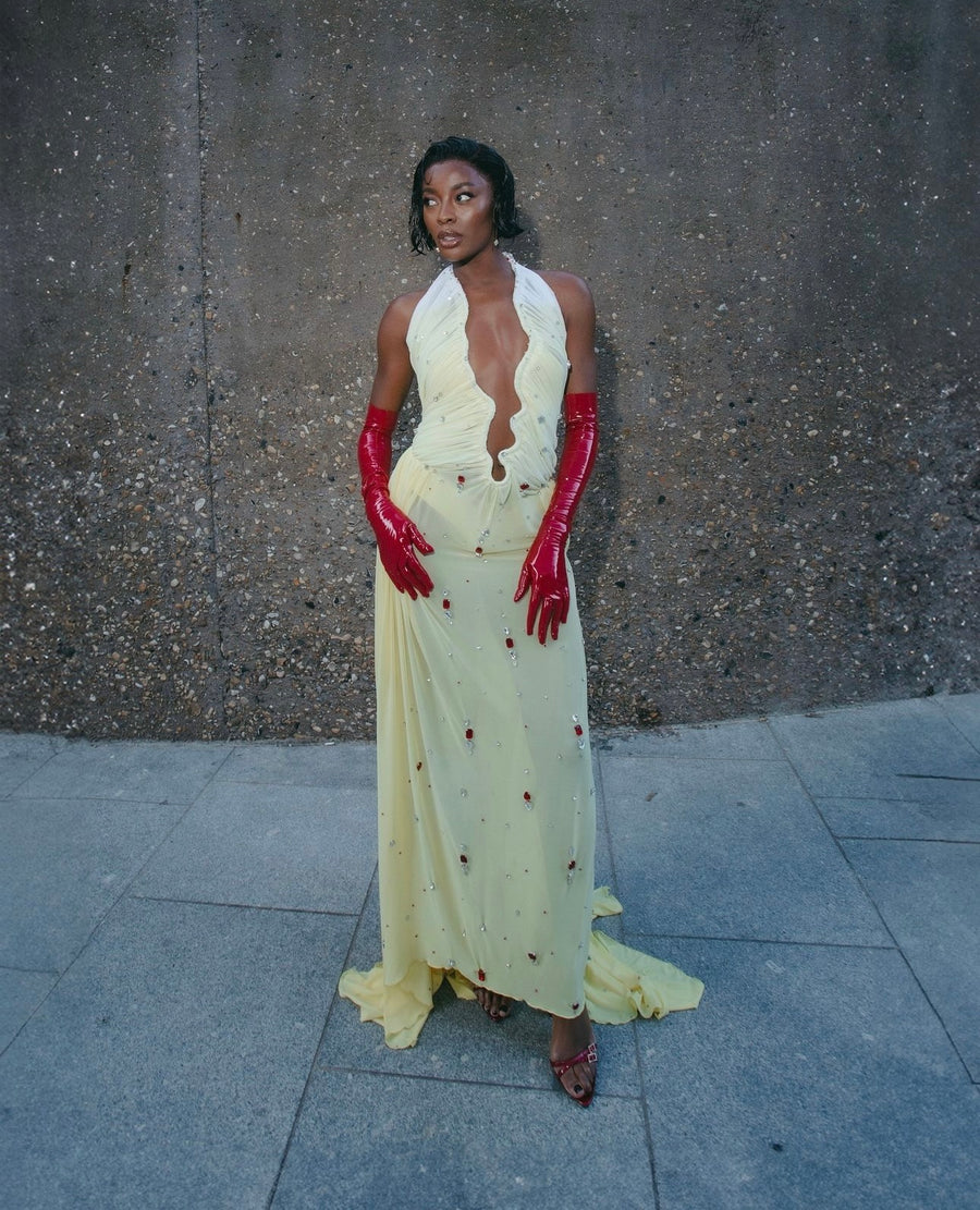 AJ Odudu wearing a pale yellow Rohmane halter gown