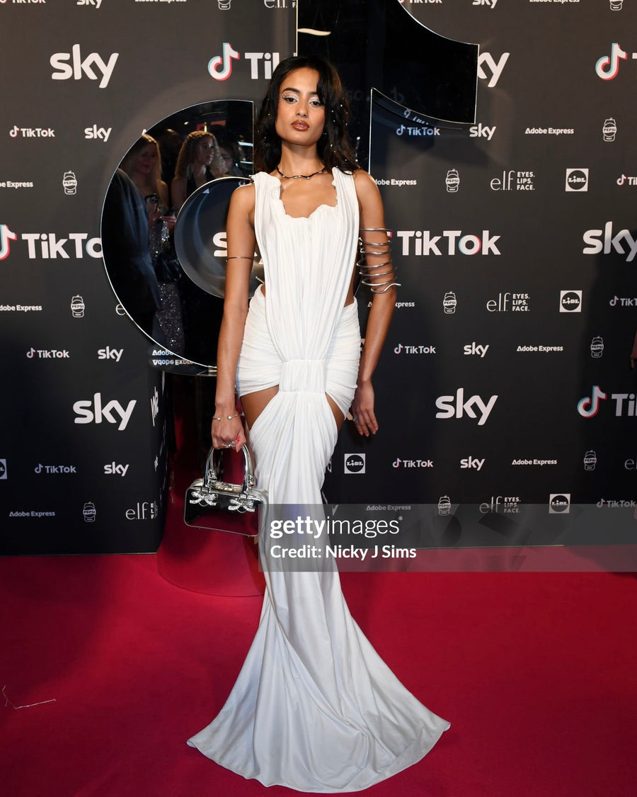 Sabrina Bahsoon on the red carpet in a white Rohmane draped gown